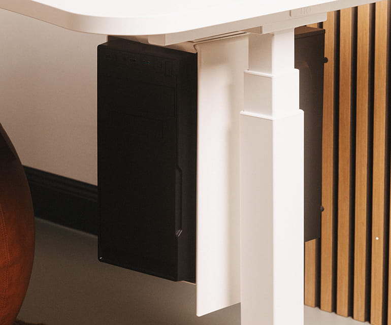 Bureau assis-debout blanc avec un support PC monté sous le bureau, tenant solidement un ordinateur de bureau.