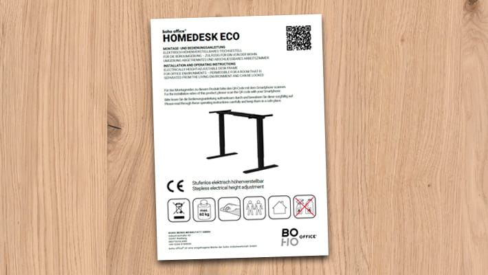 Anleitung für HOMEDESK ECO Schreibtisch mit QR-Code und Warnsymbolen.